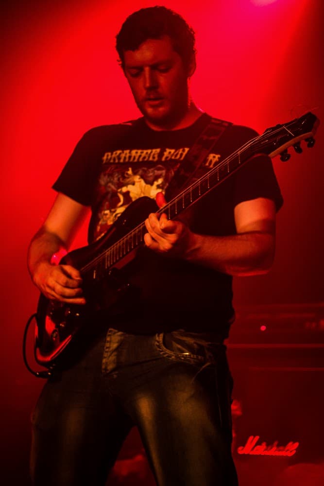 Gary Treanor, Founder and Lead Educator, playing guitar at a Marshall amp